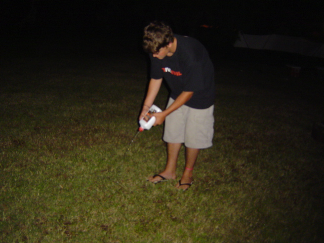 Davey writing his name in the grass with lighter fluid